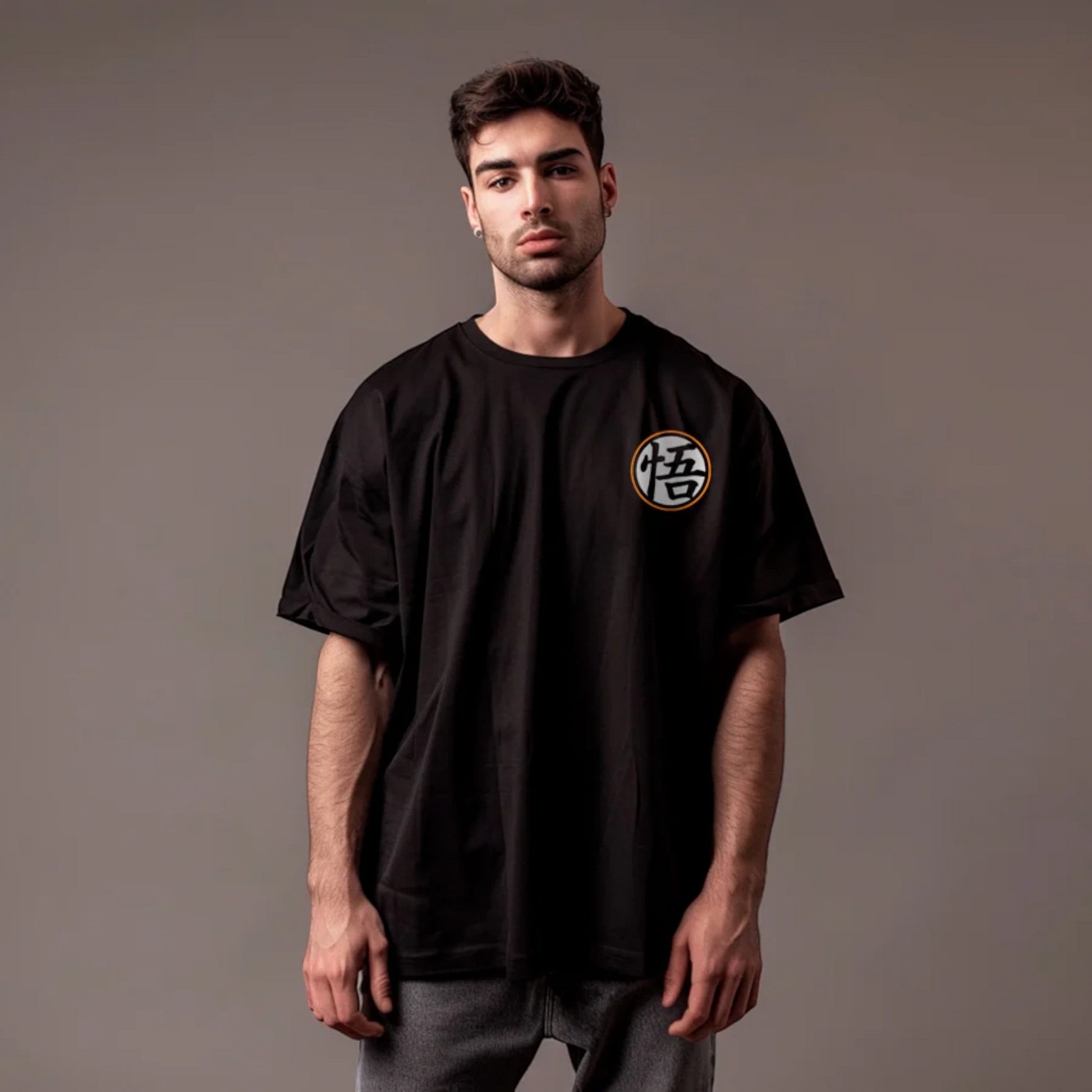 Modelo vistiendo playera oversize negra de Dragon Ball con símbolo kanji de Goku en el pecho, diseño con cuello redondo