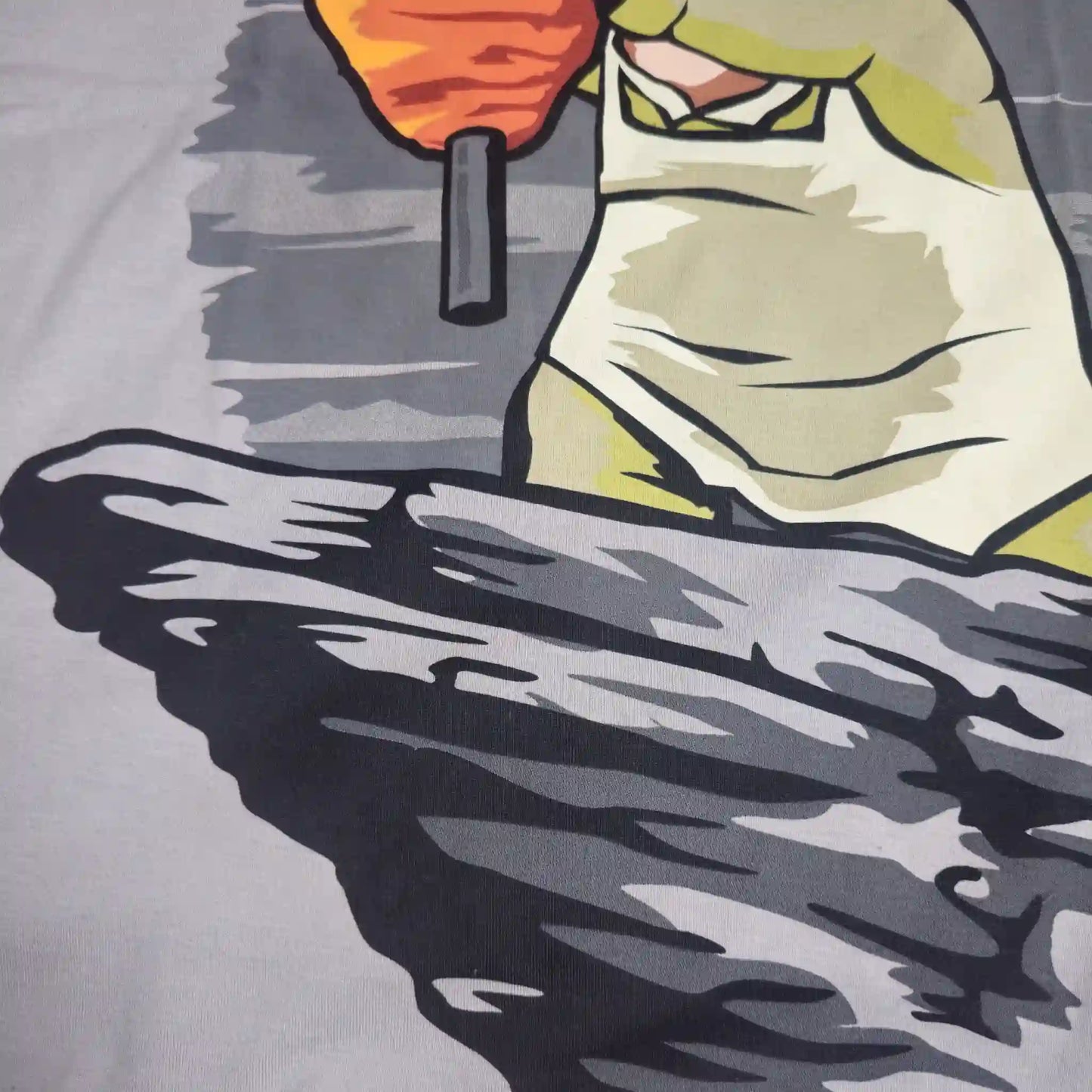 Parte inferior del diseño en playera con taquero y trompo al pastor sobre una plancha estilo caricatura
