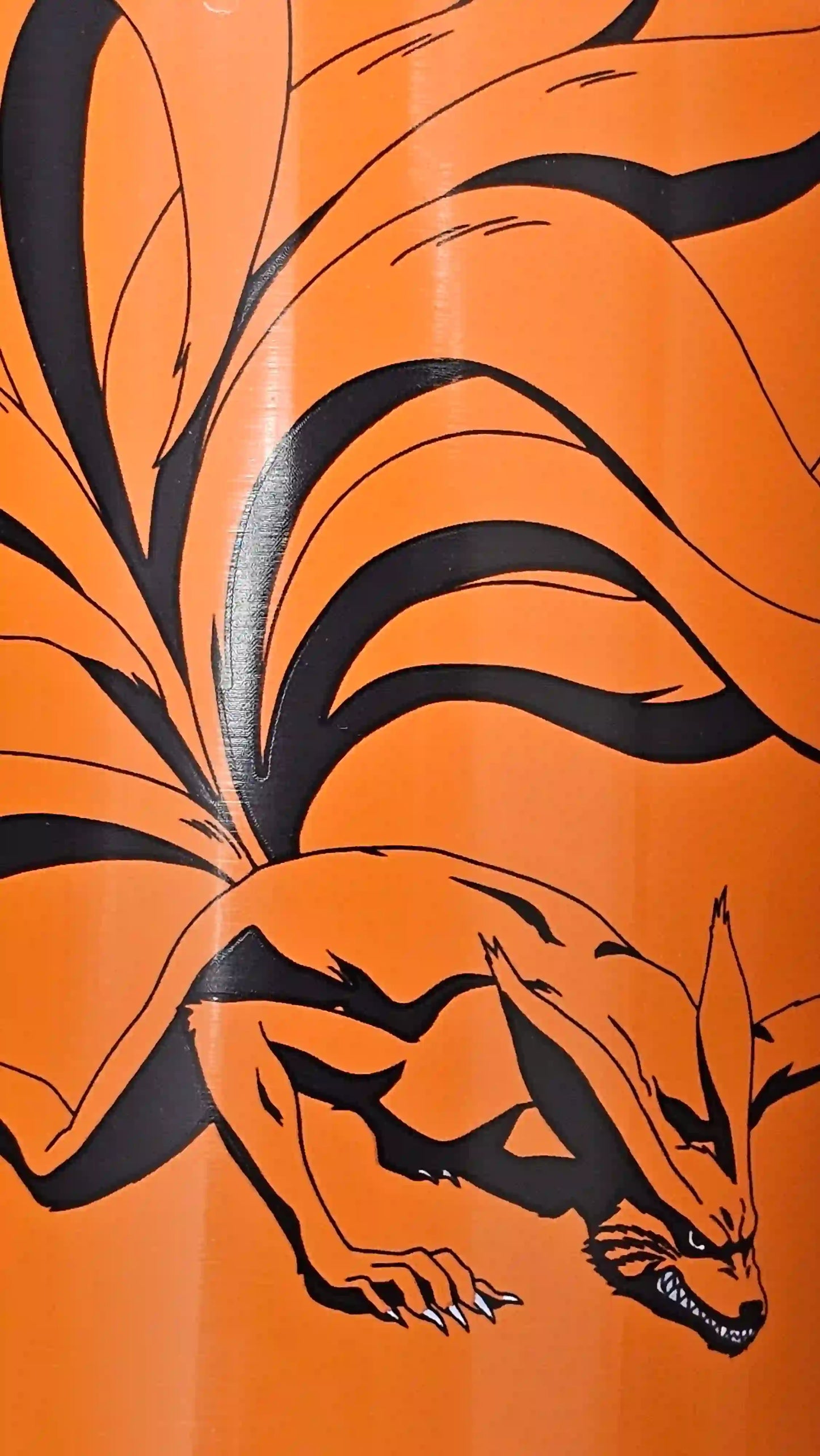 Primer plano del diseño de Kurama en el termo naranja de Naruto Shippuden
